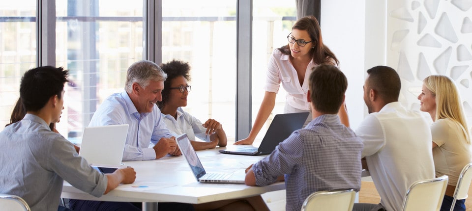 How To Improve Communication at Work - Team around table - Feature